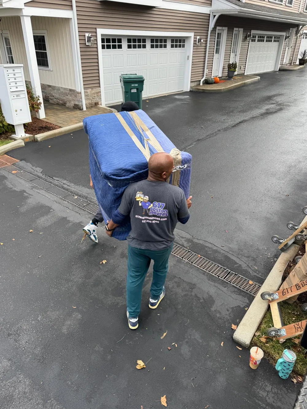 617 Boston Movers crew carrying wrapped furniture