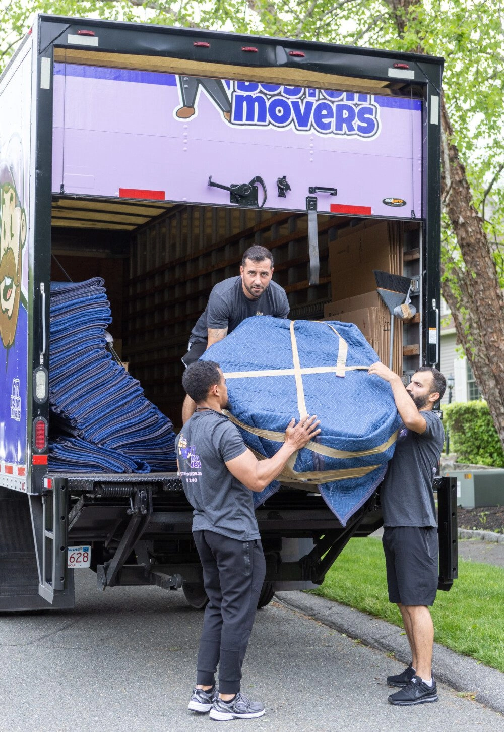 Boston movers loading furniture into the back of a moving truck